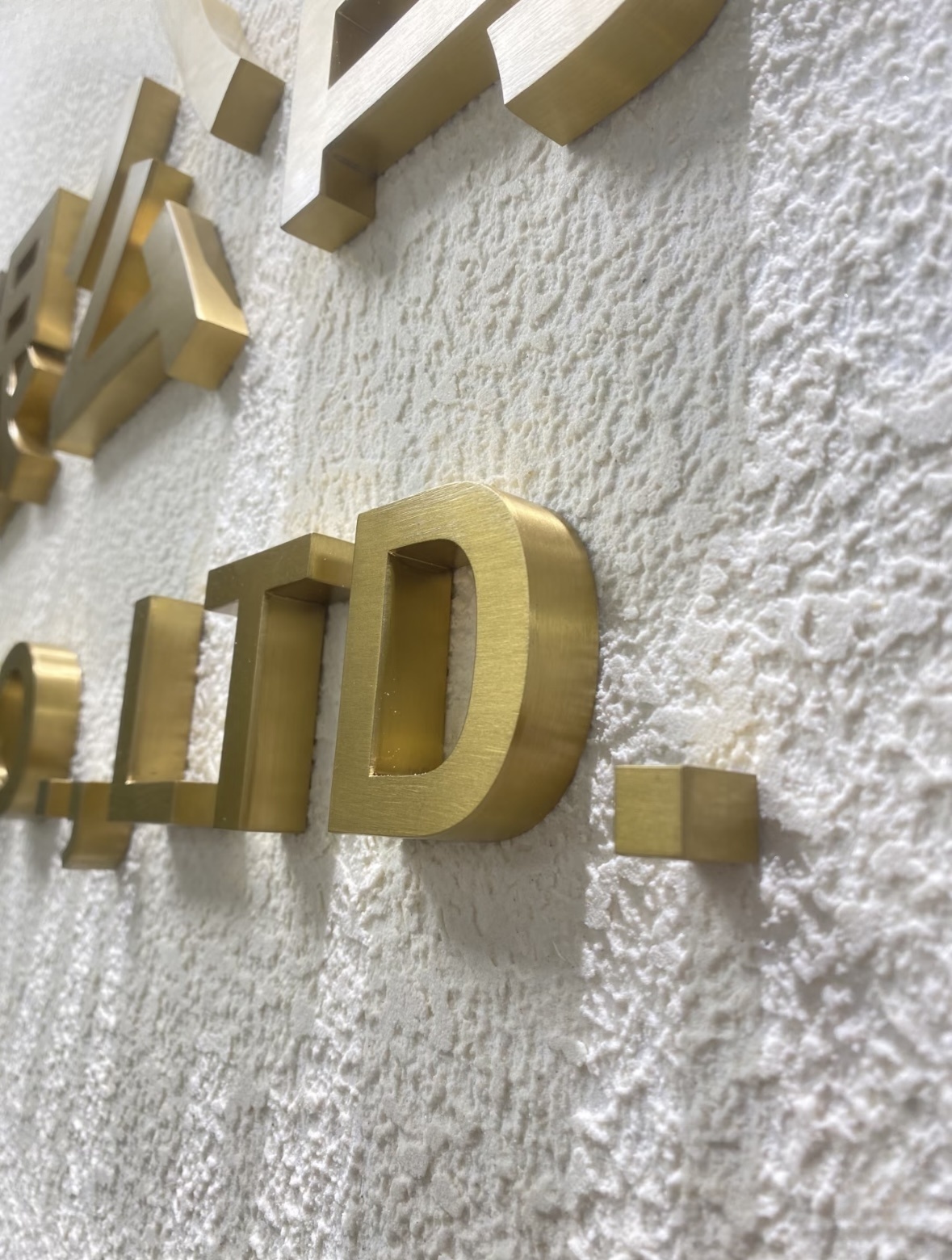Gold plated brushed stainless steel dimensional letters, business wall logo