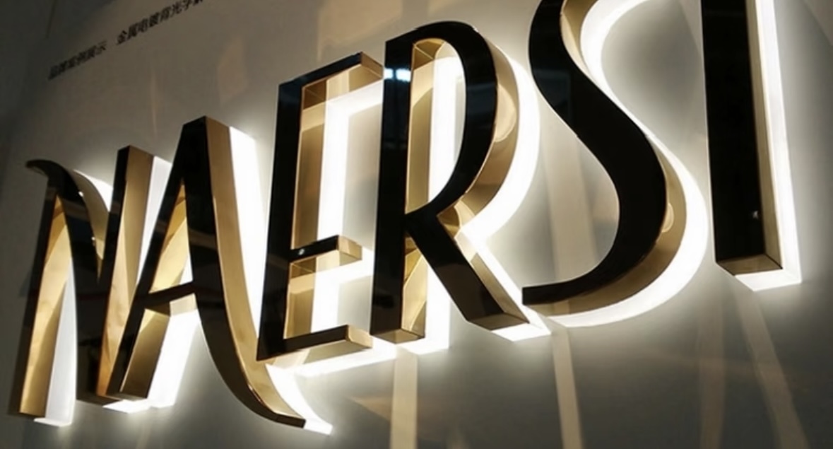 Backlit gold stainless steel brand letter sign