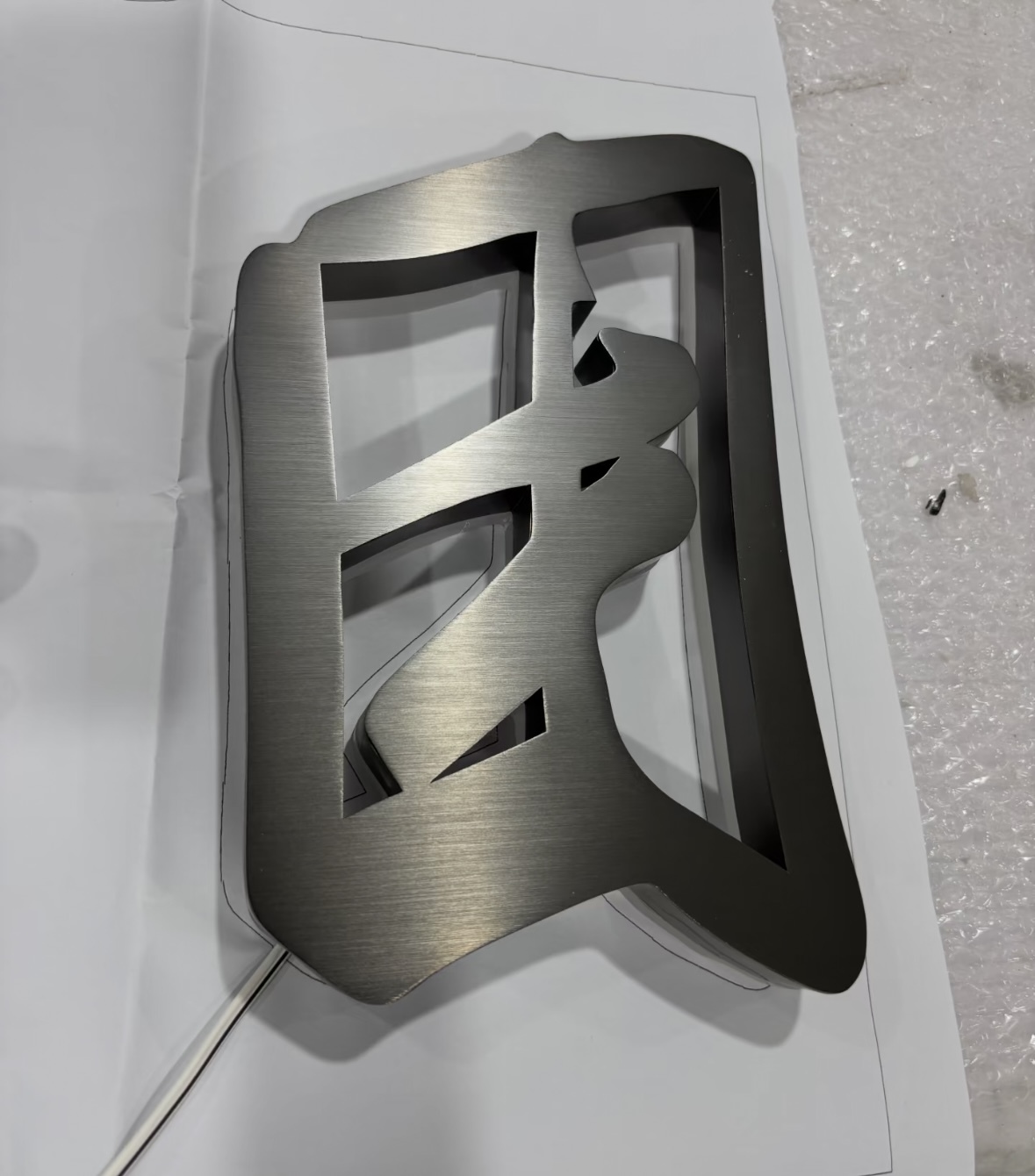 Brushed stainless steel raised metal letters, business wall sign