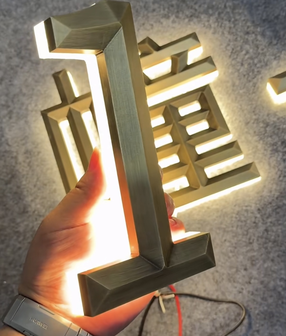 Backlit golden metal letter product display