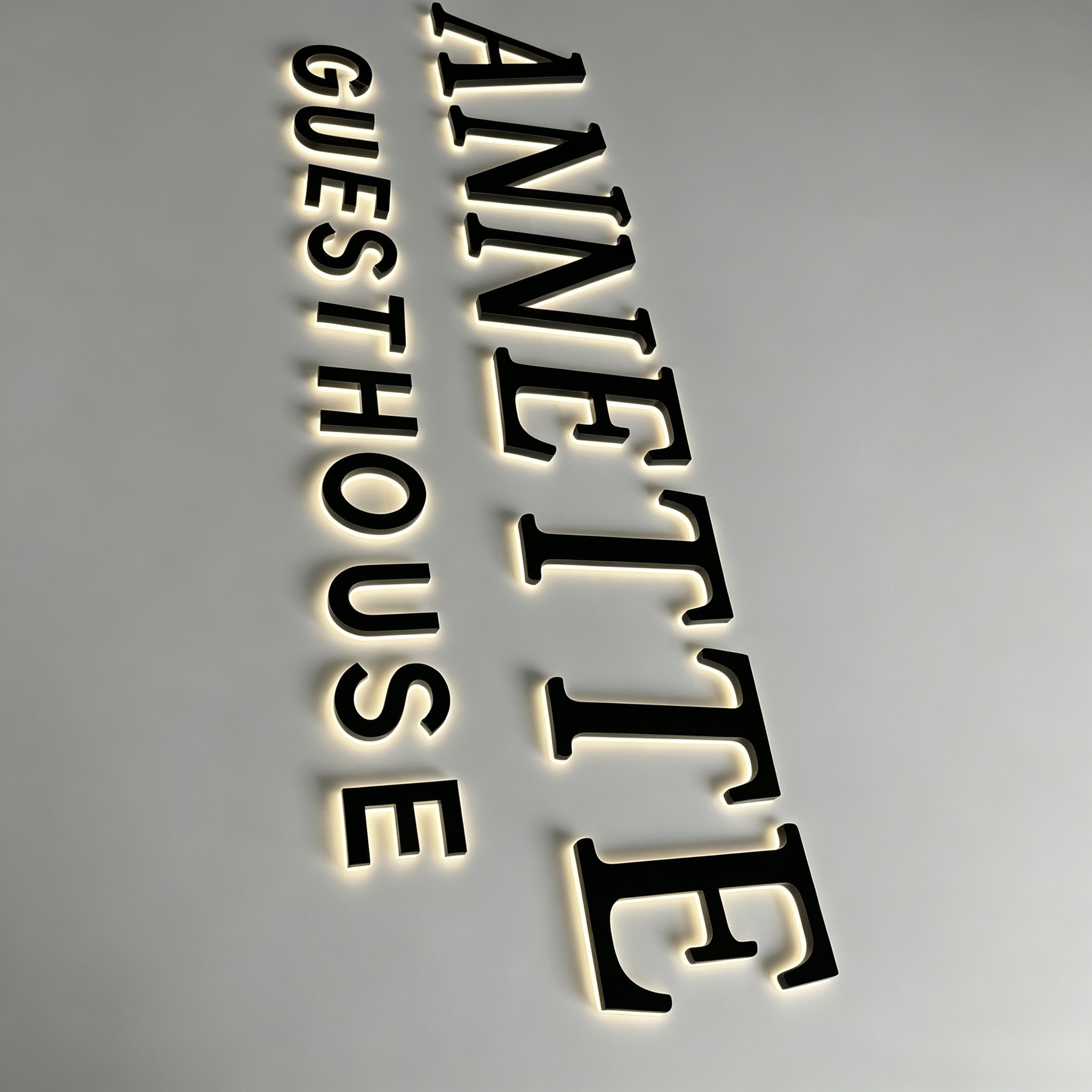 Backlit metal guesthouse letter sign