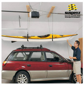 Shows a person using the fully set up hoister to lift a kayak off his car.