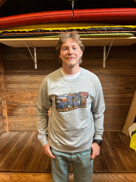 Image of experience coordinator Jeffrey looking handsome while modeling the RRT postcard Crew