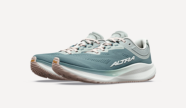 Profile view of both shoes shoes a prominent Vibram logo on the tip of the sole, the white midsole fading to the sea green top, and a premium looking synthetic breathable upper.