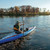Image of the airvolution on the water with someone paddling it.