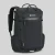 Looking at the corner of the backpack standing up against a white backdrop. The backpack is black and rectangular and is shown to have a front waterproof zip, 2 vertical daisy chains, and a large front mesh pouch on the bottom three quarters of the backpack. Also pictured are the large carry handles on top of the backpack.