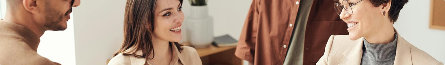 People smiling and talking in an office environment
