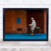 Blurry Motion Man On Bike Orange Building Wall Art Print