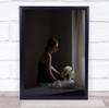 Woman holding white flowers by curtain Wall Art Print