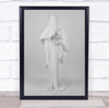 creepy all white person in robe holding black circular flower Wall Art Print
