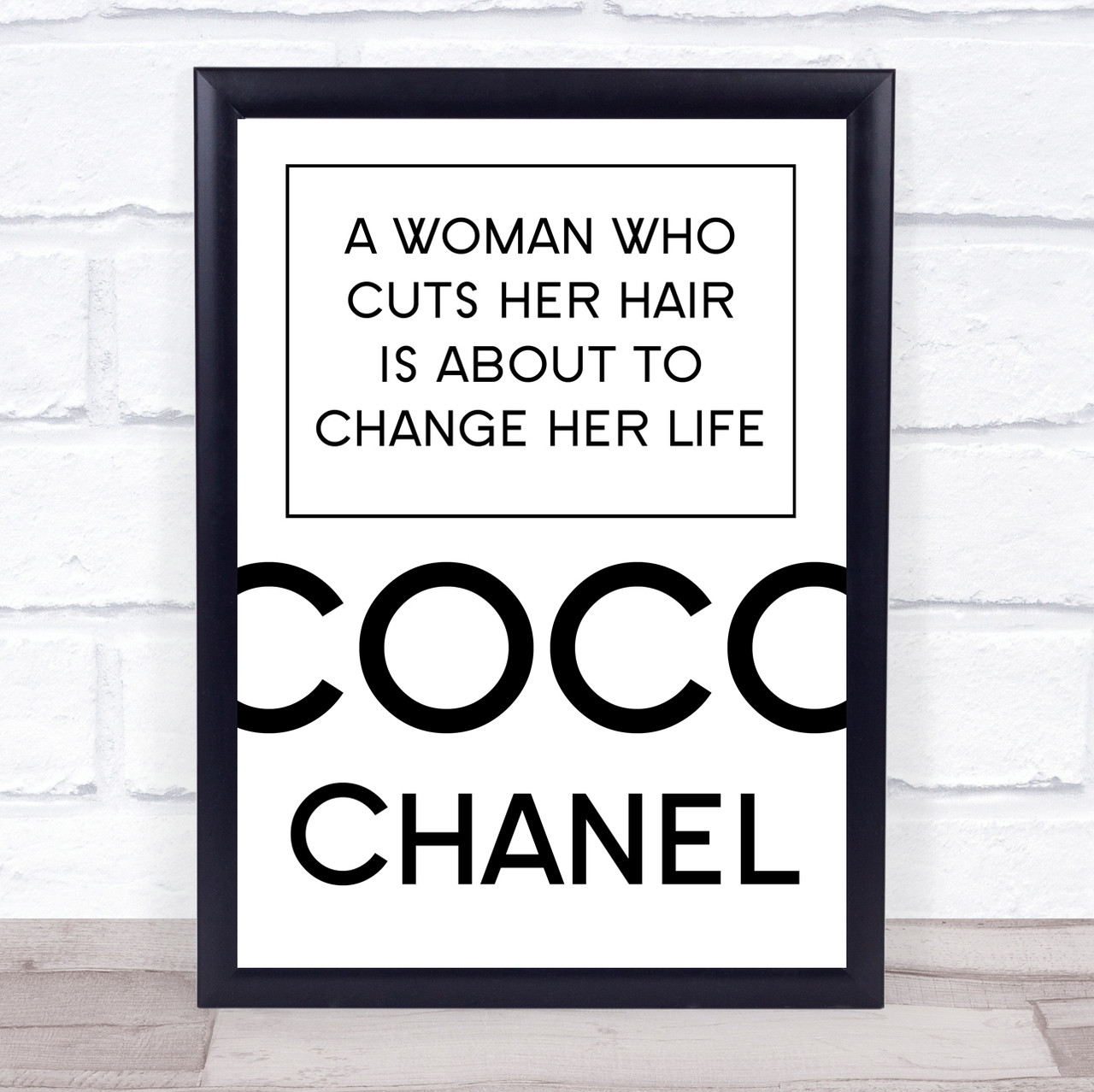 Framed Coco Chanel quotation artwork using bold black typography