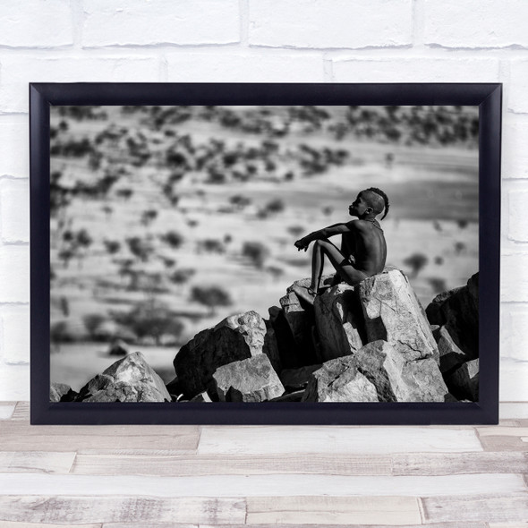 Africa Kid sitting rocks staring Black and white Wall Art Print