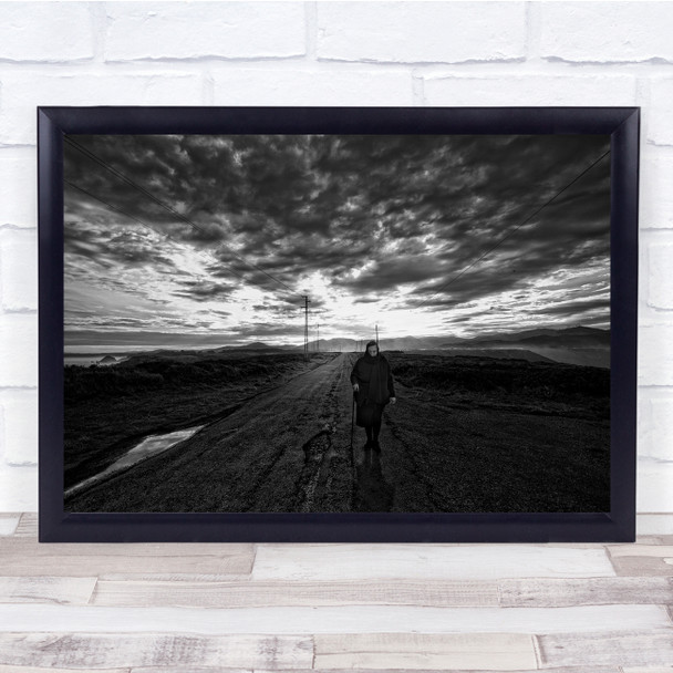 black and white old woman walking isolated dirt road Wall Art Print