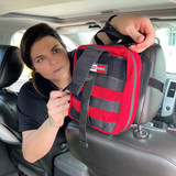 Red Rescue Essentials IFAK Rip-Away Pouch, being installed onto seat