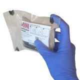 Rescue Essentials Mini Compression Bandage, in packaging being held in hand
