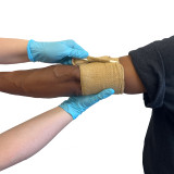 Rescue Essentials Mini Compression Bandage in use on arm