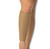 A woman's leg with a beige NeoPhysio Medical Grade Breathable Calf Support. A woman's leg with a beige NeoPhysio Medical Grade Breathable Calf Support.