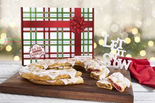 Kris Kringle Holiday Gift Box with a Kringle sitting near the box.