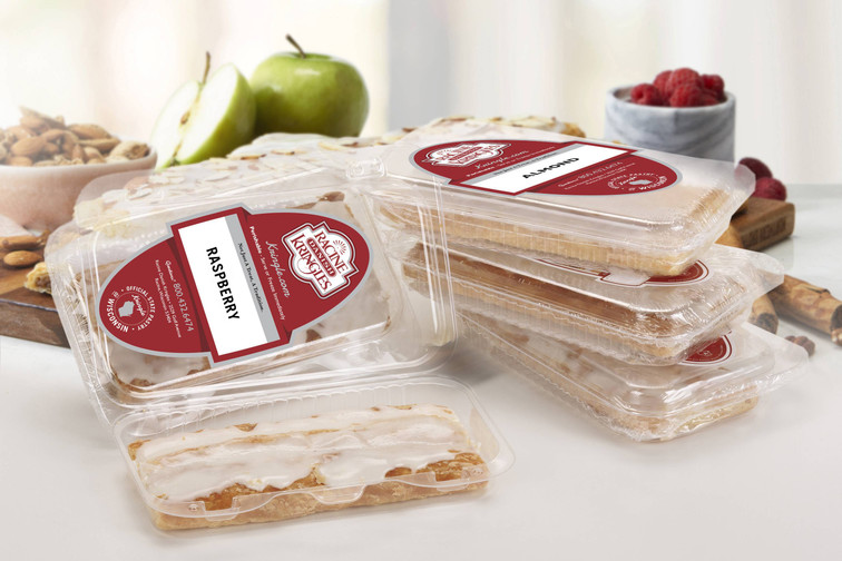 Single Serve Kringle Gift Set on a white table with raspberries in a marble bowl and sliced green apples near the kringles.