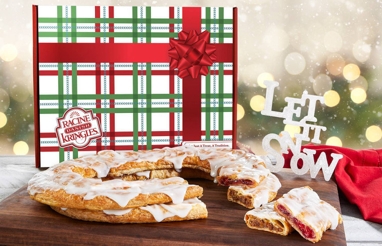 Gingerbread and Cherry Kringle sitting on a wooden cutting board in front of the Santa Claus Holiday Gift Box.