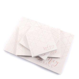 a staggered stack of 4 varying sized empty magnetic cosmetics palettes