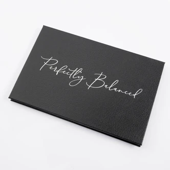 a black eye shadow palette with silver lettering
