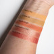 a set of five complimentary peachy and orange eye shadow swatches with names.
