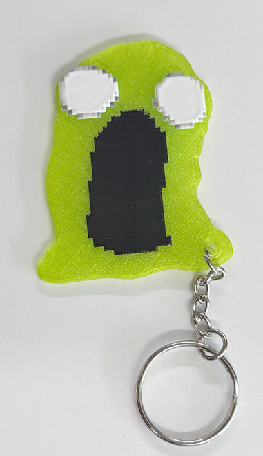 This playful Green Gooey keychain, inspired by the iconic ModWiggler mascot is 3D printed in vibrant green with layered black and white details.