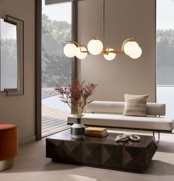 A modern sitting room with the Tricia Chandelier installed over the coffee table. 