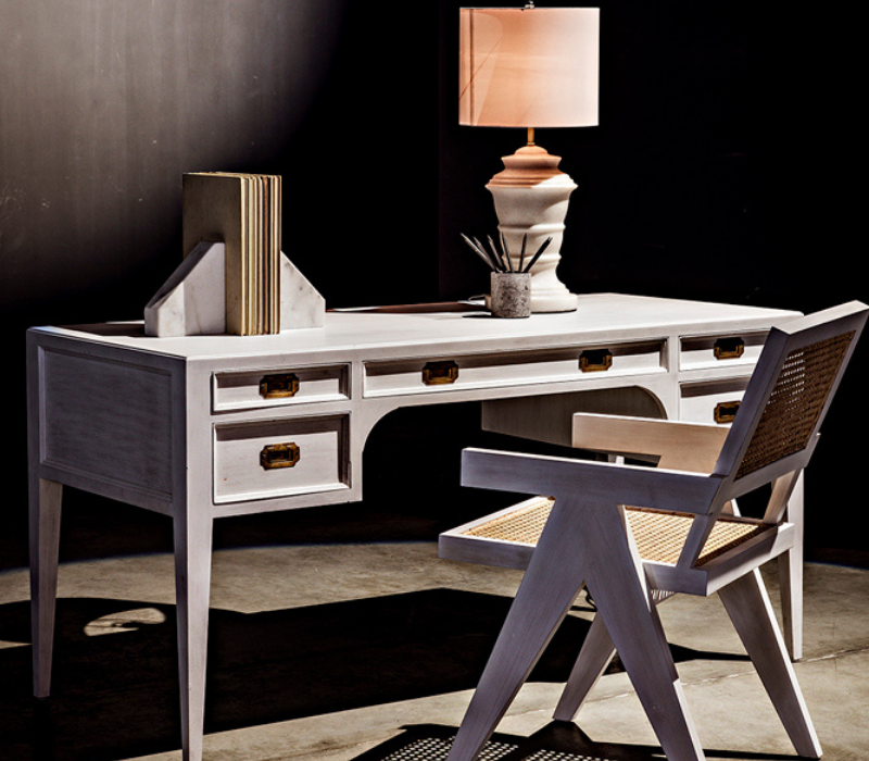 Africa Desk and other Noir pieces styled together in a home office setting with a black backdrop and concrete flooring.