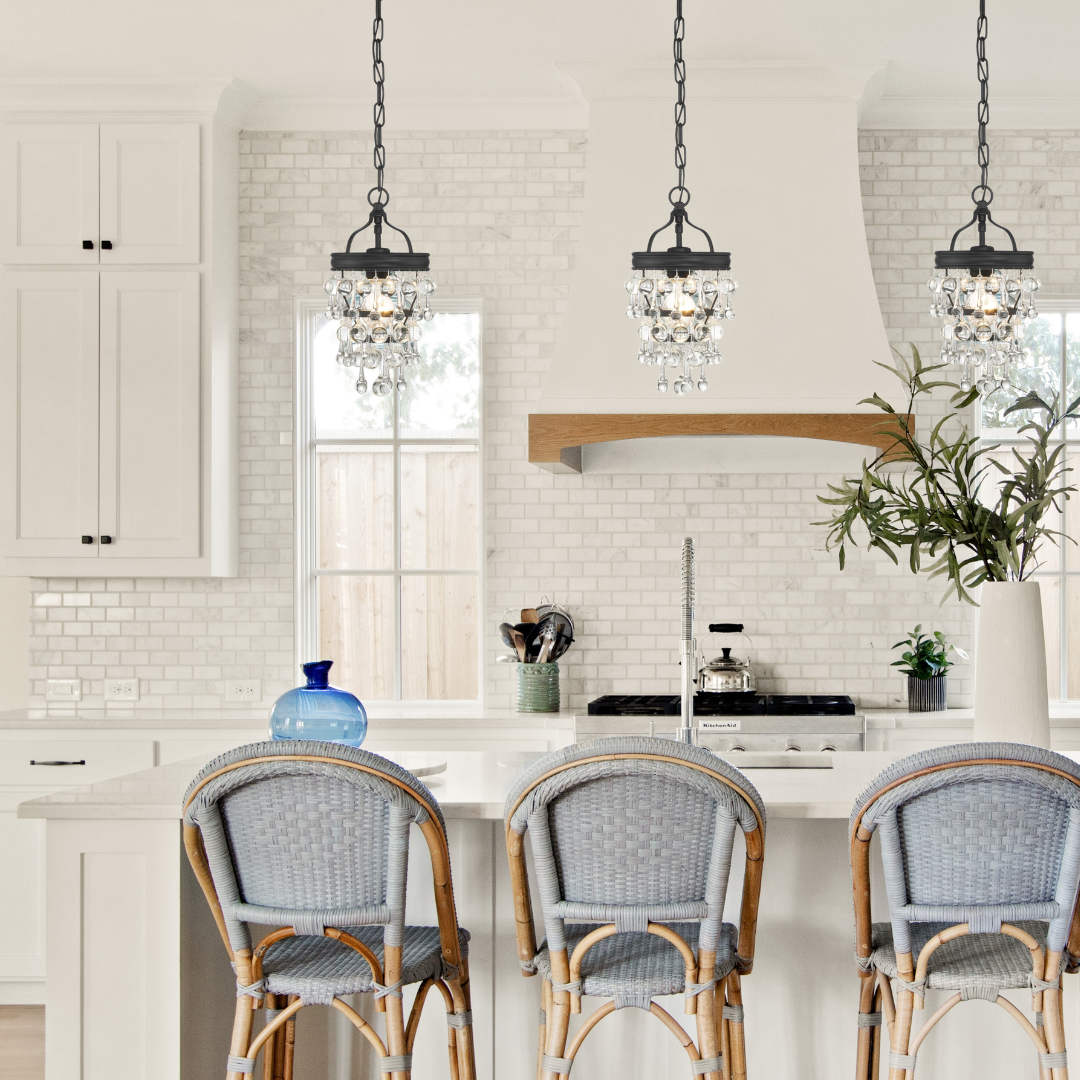 A white transitional kitchen with three Calypso pieces installed over the island