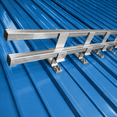 Double bar snow guard system installed on blue exposed fastener metal roof with galvanized brackets