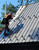 Roofer installing a metal roof with Ridge Pro.