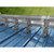 Double bar snow guard system installed on blue exposed fastener metal roof with galvanized mounting brackets