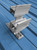 SnoCleat SC2B double bar snow guard back view showing wide aluminum SnoCleat base with six predrilled fastener holes and die-cut foam gasket