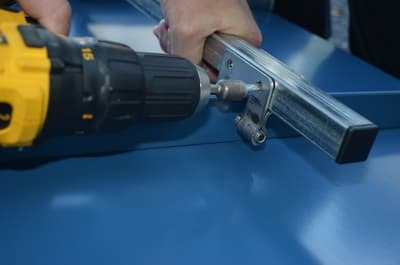 Attaching SnoBar, ColorBar or WindBar rail to standing seam clamps with Tek screws