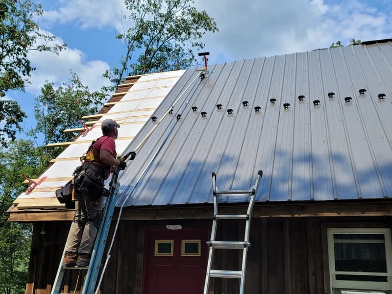 Roofer using the RidgePro Roof Anchor while installing Kodiak SnowCatcher snow guards