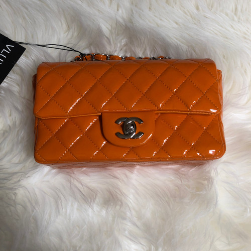 VAN CLEEF 
ARPELS Chanel Classic Mini Rectangular Orange Quilted Patent with silver hardware 