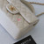 VAN CLEEF 
ARPELS Chanel Classic Mini Rectangular with Top Handle 21S Beige Quilted Caviar with brushed gold hardware 