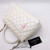 VAN CLEEF 
ARPELS Chanel Coco Handle 20K Iridescent White Quilted Caviar with shiny light gold hardware 