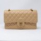 VAN CLEEF 
ARPELS Chanel Classic Medium Beige Quilted Caviar with gold hardware 