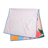 A microfibre beach towel featuring colourful prints, folded over with blue edging.