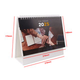 A desk calendar featuring a spiral binding, displayed upright in white, showcasing hands on a desk background.