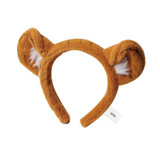 A fluffy orange headband with bear ears and white accents, featuring a small tag.