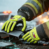 Heavy duty safety work gloves in bright yellow and grey, featuring a textured grip on a hand holding a saw amidst debris.