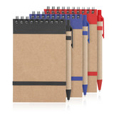 A recycled paper notepad spiral bound in brown, featuring blue, black, and red covers with matching pens. A recycled paper notepad spiral bound in brown, featuring blue, black, and red covers with matching pens.