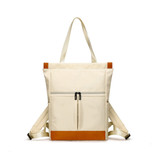 A cream convertible nylon backpack with brown accents and adjustable straps, featuring a front zippered pocket.