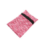 A pink and white patterned mini wearable wallet with a black zip. Features a logo on the surface.