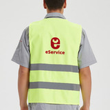 A bright yellow unisex hi-vis vest featuring horizontal reflective tape and a logo on the back.