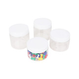 A round container set of four, featuring transparent plastic with white lids, one containing assorted push pins.